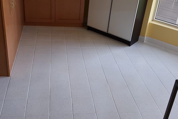 Kitchen tile floor resurfaced by Epic Resurfacing Solutions to look like new. The grout lines look like new.